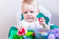 Blurred little child holding a toy vegetable in his hands on the background of dishes Royalty Free Stock Photo