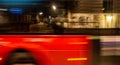 Blurred London bus at night