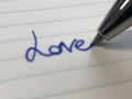 Blurred `Love` hand writing on a ruled notebook Royalty Free Stock Photo