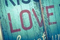 Blurred Love word printed on vintage wooden board. Calligraphy script love text