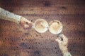 Blurred male`s and female`s hands with an cup of coffee under a glass roof with raindrops.