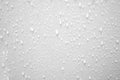 Blurred many water droplets on a white wall in a restroom area Royalty Free Stock Photo