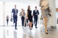 Blurred motion of business people walking at convention center Royalty Free Stock Photo