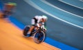 Blurred motion of fast cyclist competing indoor