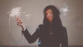 Blurred in motion image of young woman dancing with burning sparkler in her hands in the night city street, retro color Royalty Free Stock Photo