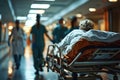 Hospital Patient Being Transported on Gurney by Medical Staff. Royalty Free Stock Photo