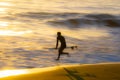 Blurred in motion running surfer enter water Royalty Free Stock Photo