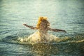 Blurred motion silhouette of happy kid playing in the sea. Child having fun on ocean outdoors. Summer vacation and Royalty Free Stock Photo