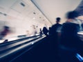 Blurred motion silhouettes of unrecognizable male with backpack inside Parisian