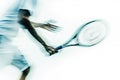 Blurred motion of a tennis player swinging racket during an intense match