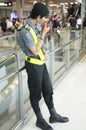 Blurred motion of thai airport security guard standing and use w