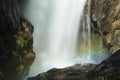 Blurred motion of a waterfall with a rainbow in mist. Royalty Free Stock Photo