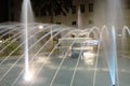 Blurred movement of water in the fountain, illuminated with lights