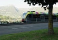 Blurred moving regional colorful train in Meran city Royalty Free Stock Photo