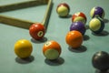 A blurred multicolored billiard balls on a blue table cloth with shadows and a triangle. numbers on billiard balls