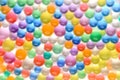 Blurred multicolored cheerful background with the texture of hydrogel balls Royalty Free Stock Photo