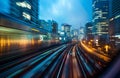 Blurred night cityscape from the window of a high-speed train, capturing dynamism of urban travel