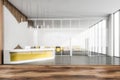 Blurred office reception area with yellow table
