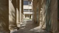Blurred outdoor courtyard with sunlit columns, shadows, and defocused architectural details Royalty Free Stock Photo