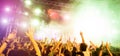 Blurred people dancing and having fun in summer festival party outdoor - Crowd with hands up celebrating fest concert event - Royalty Free Stock Photo