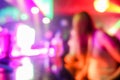 Blurred people dancing with original laser color lights - View of new generation disco club - Defocused image - Concept of Royalty Free Stock Photo