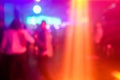 Blurred people dancing with original laser color lights - View of new generation disco club - Defocused image - Concept of Royalty Free Stock Photo