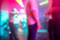 Blurred people dancing with original laser color lights - View of new generation disco club - Defocused image - Concept of Royalty Free Stock Photo