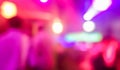 Blurred people dancing with original laser color lights - View of new generation disco club - Defocused image - Concept of Royalty Free Stock Photo