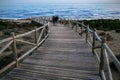 Blurred people on lumber path near sea Royalty Free Stock Photo