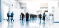 Blurred people walking in a trade fair hall Royalty Free Stock Photo
