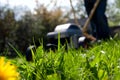 Blurred person mowing the lawn with a lawn mover Royalty Free Stock Photo