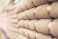 Blurred photo of Big shelf with a beige stack towels