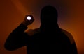 Blurred photo. Burglar in dark clothes holding the flashlight. Dangerous robber in mask with a torch. Criminal man Royalty Free Stock Photo