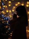 Blurred photo of cute little girl decorates christmas tree. Royalty Free Stock Photo