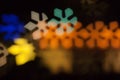 Blurred photo of defocused bokeh colorful lights in the shape of snowflake Royalty Free Stock Photo