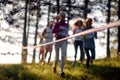 Blurred photo of group of athletes running through forest. Marathon in the forest. Sport, running, mountain, marathon concept