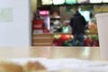 Blurred photo of a man standing at the cafe counter with his back