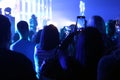 Blurred photo people at a concert stand and shoot on the phone Royalty Free Stock Photo