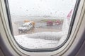 Blurred photo of rain drops from airplane window and airport run Royalty Free Stock Photo