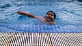 Blurred photo of a young asian happy kid swimming in the pool at the resort during the summer Royalty Free Stock Photo