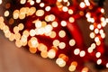 Blurred picture of christmas tree with lights and spruce branch. Defocused new year background with space for text Royalty Free Stock Photo