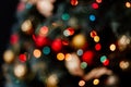 Blurred picture of christmas tree with lights and spruce branch. Defocused new year background with space for text Royalty Free Stock Photo