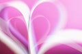 Blurred pink gentle background with hearts shaped paper pages, love and Valentine`s day concept, selective focus Royalty Free Stock Photo