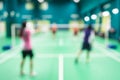 Blurred players in badminton court