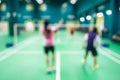 Blurred players in badminton court