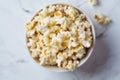 Blurred popcorn bowl background, defocus concept, top view. Snack for movie