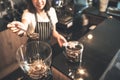 Blurred portrait of a barista Asian woman Scooping roasted coffee beans into a coffee grinder Royalty Free Stock Photo