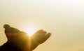 praying hands of a man for blessings his god through the sunset on sky background Royalty Free Stock Photo