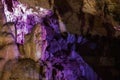 Blurred purple abstract background of stalactites, stalagmites and stalagnates in Sfendoni cave, underground, horizontal