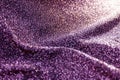 Blurred purple bokeh of satin fabric for background, purple fabric rippled elegant, creased silk scarf textile, bokeh glitter